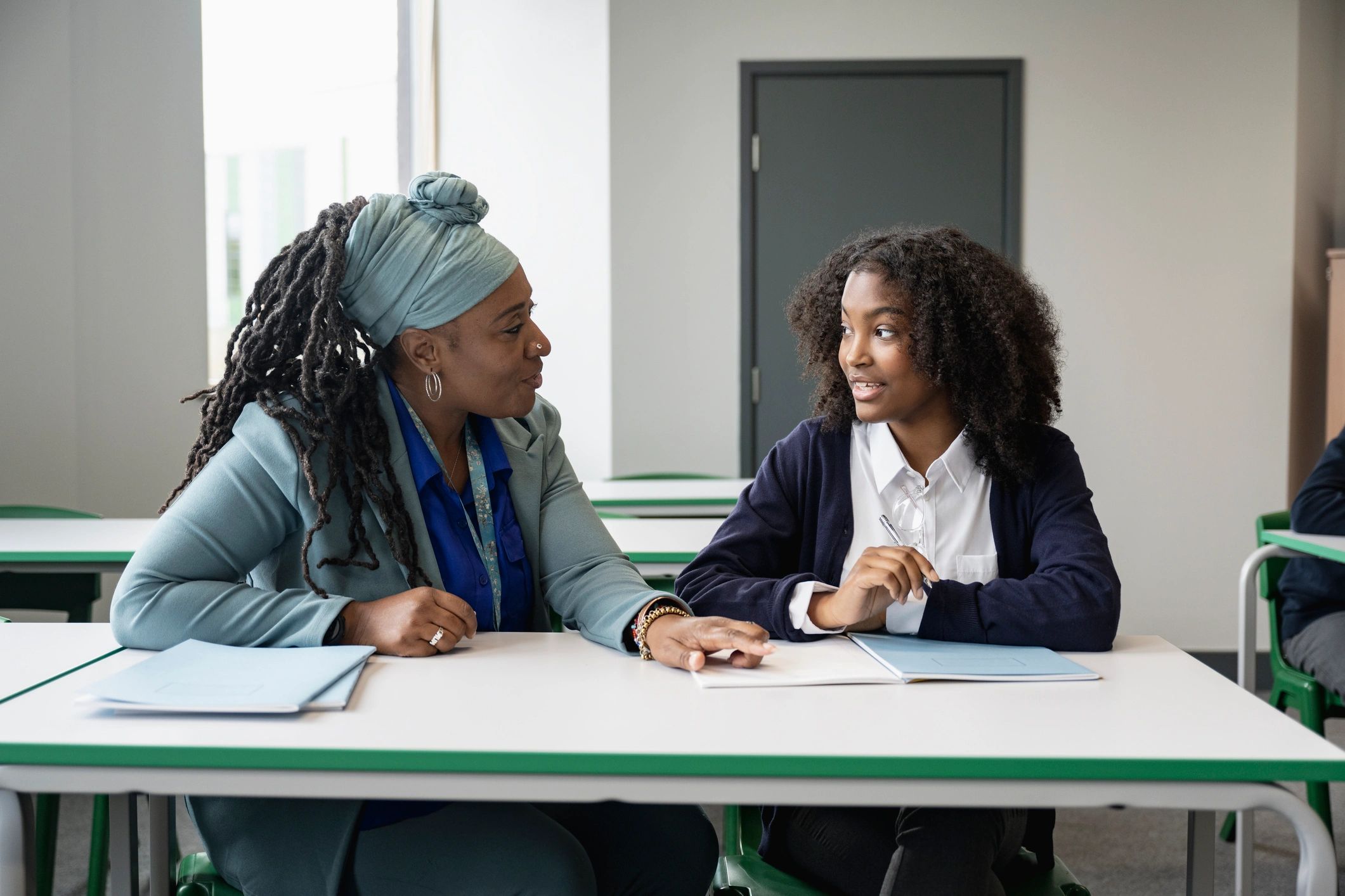 Tutor working with a student during a math lesson