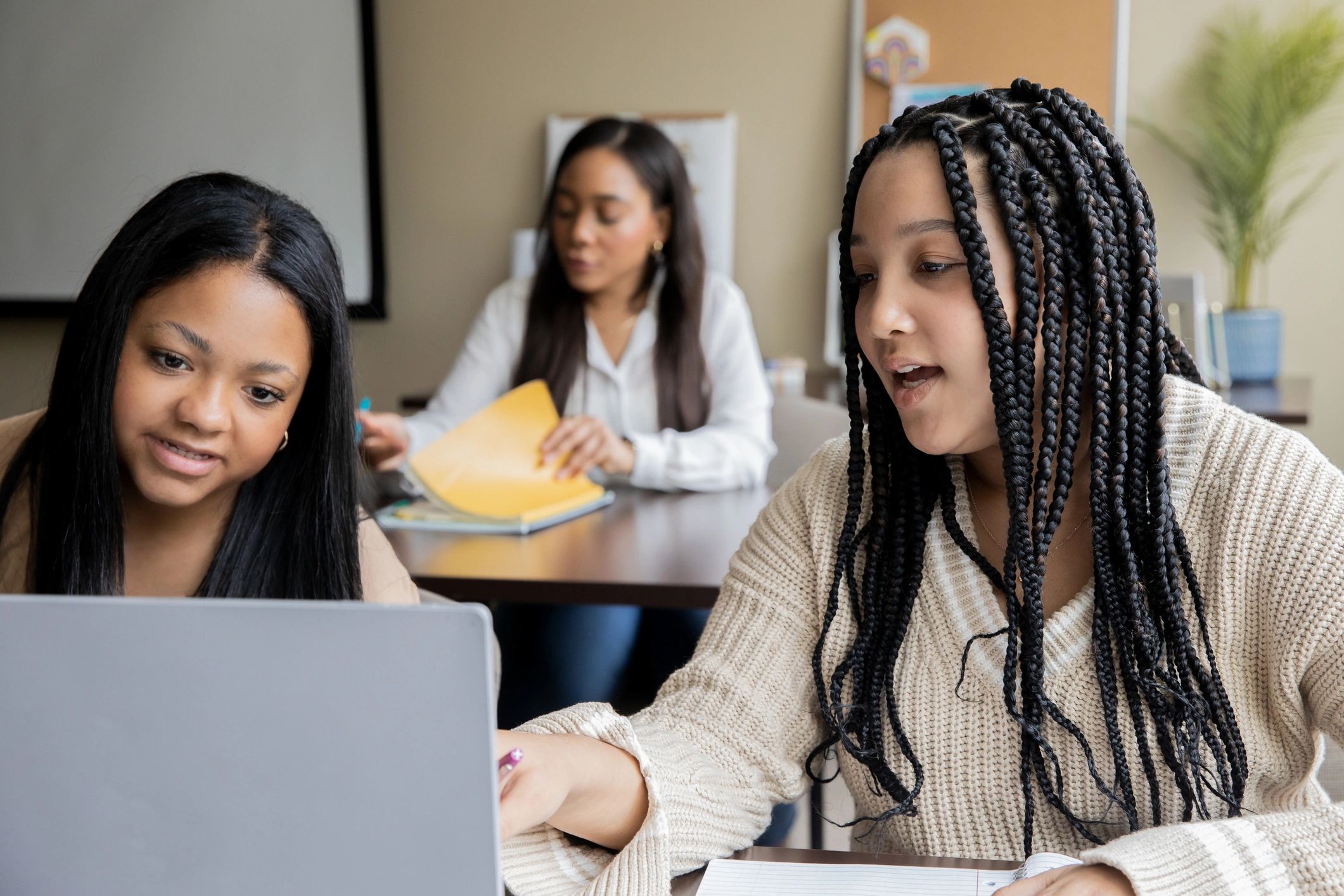 Students working together on math using a laptop