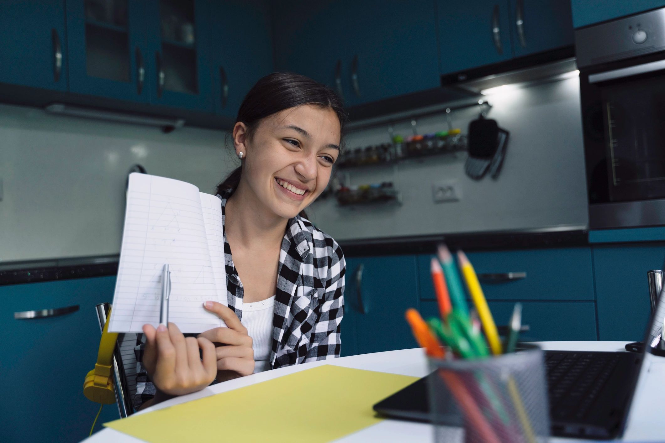 Student smiling while studying at home