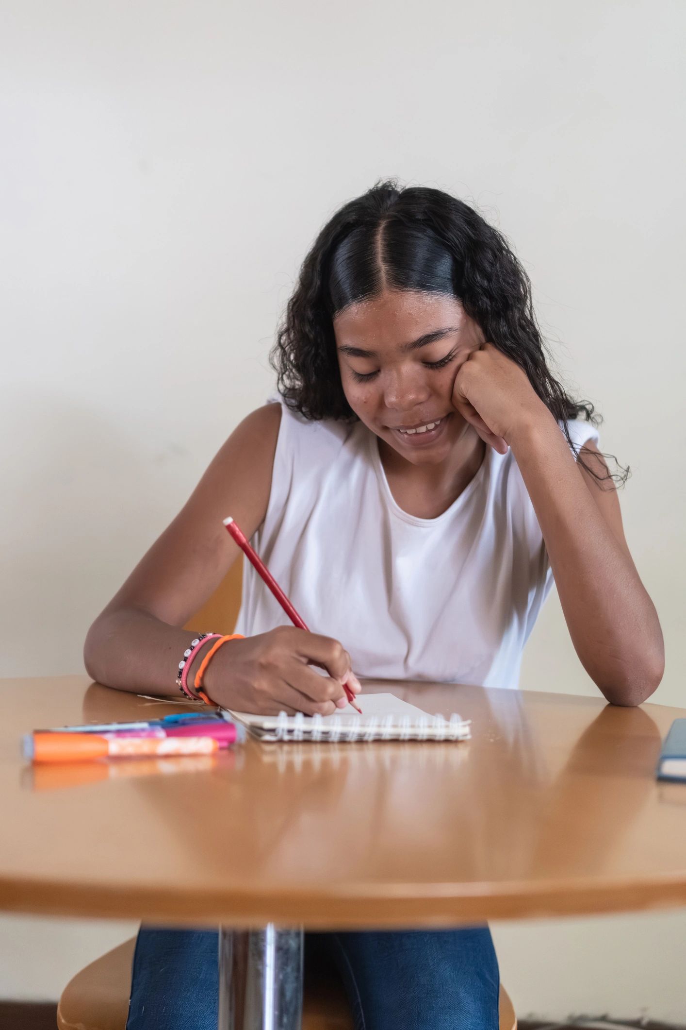 Student studying and taking notes at a desk